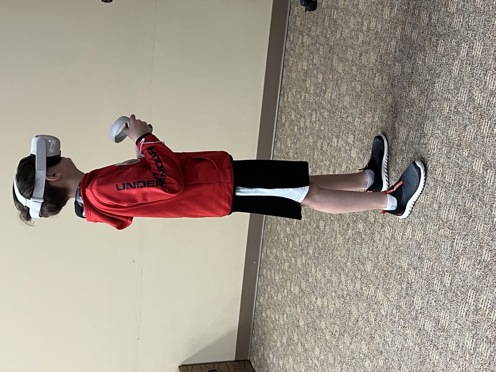 A young Kentucky student turns while using a VR headset to explore careers.